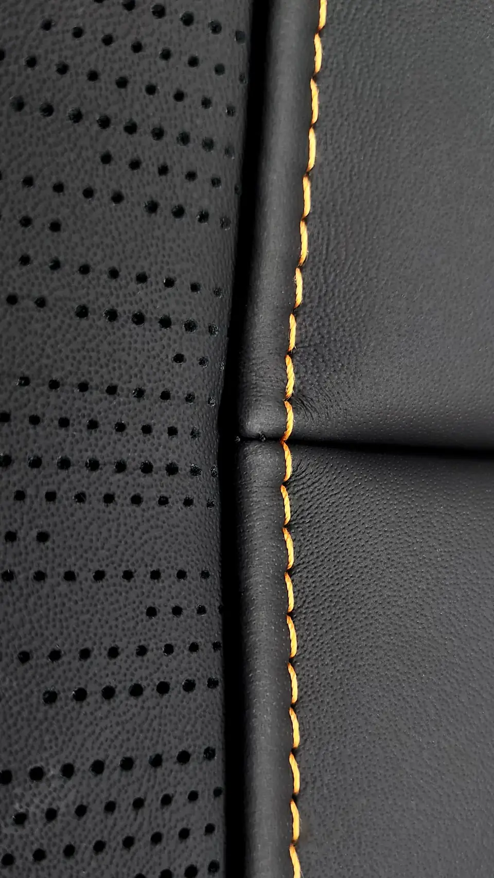 Rolls-Royce Cullinan seat in black perforated leather with orange stitching